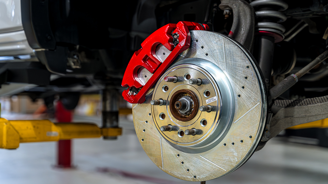 Painted red calipers on Ram with new drilled and slotted rotors
